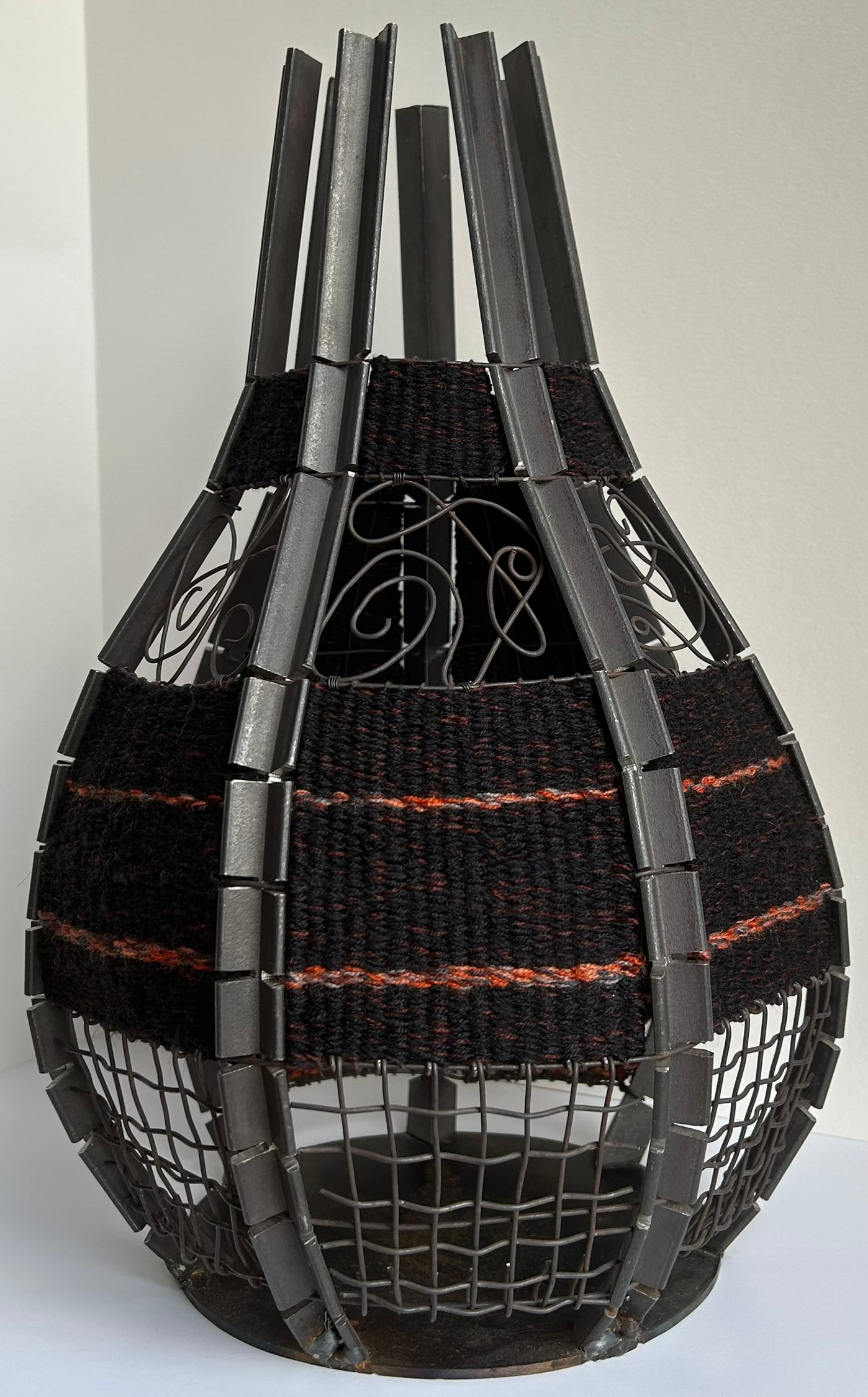 A vessel made of steel with tapestry and wire elements